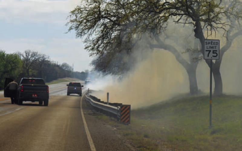 A grass fire along U.S. Highway 281 South past the entrance to Lampasas High School sent smoke across the roadway Wednesday afternoon, and area fire crews had to be called in to assist the Lampasas Fire Department in putting out the blaze. ERICK MITCHELL | DISPATCH RECORD