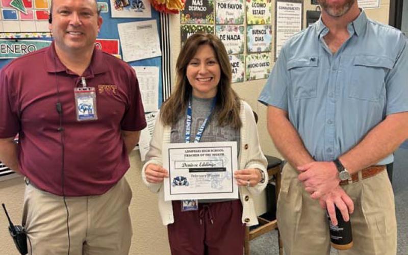 Spanish teacher Denisse Eddings has been selected as a Teacher of the Month at Lampasas High School. “She is a quick learner and demonstrates what a good teacher looks like with her calm demeanor and great relationships with her students,” said Assistant Principal Ryan Race. On hand to congratulate Eddings are Principal Paul Weinheimer, left, and Clay Phillips of Texas Farm Bureau Insurance. COURTESY PHOTO
