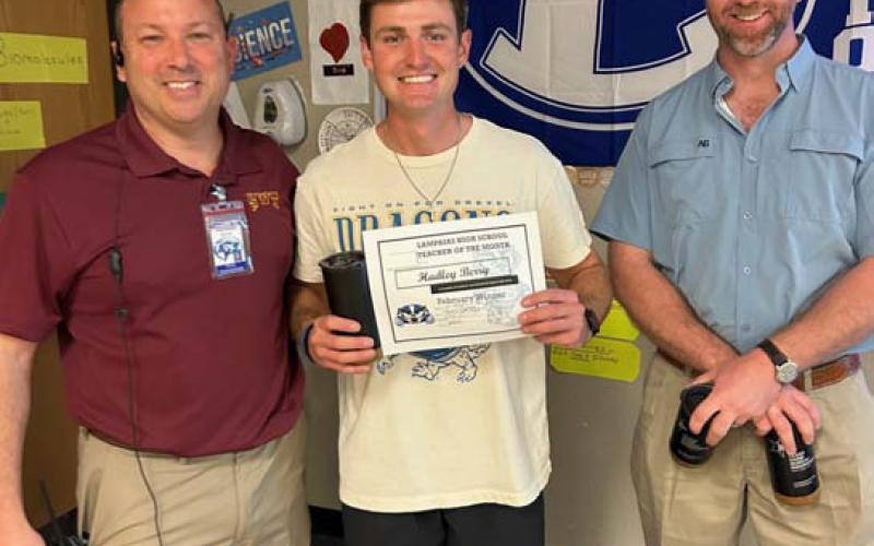 Coach Hadley Berry, center, earned Teacher of the Month accolades because “his ability to connect with his students on and off the field is unparalleled. This has led him to fantastic STAAR scores,” according to Assistant Principal Ryan Race. With Berry are Principal Paul Weinheimer, left, and Clay Phillips of Texas Farm Bureau Insurance. COURTESY PHOTO