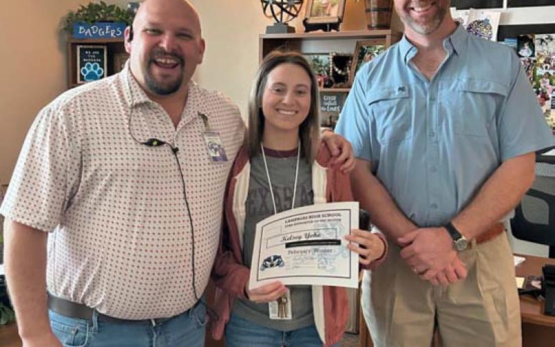 Support Staff of the Month for February is Kelsey Yoho, who works in the Career and Technical Education department. Assistant Principal Ryan Race, at left, said Yoho “is always ready and willing to help anytime there is a need. She continues to step in and assist with a smile on her face.” Also pictured is Clay Phillips of Texas Farm Bureau Insurance. Not pictured: Lisa Singleton, who is a long-term substitute at the high school campus and was selected Substitute of the Month. COURTESY PHOTO