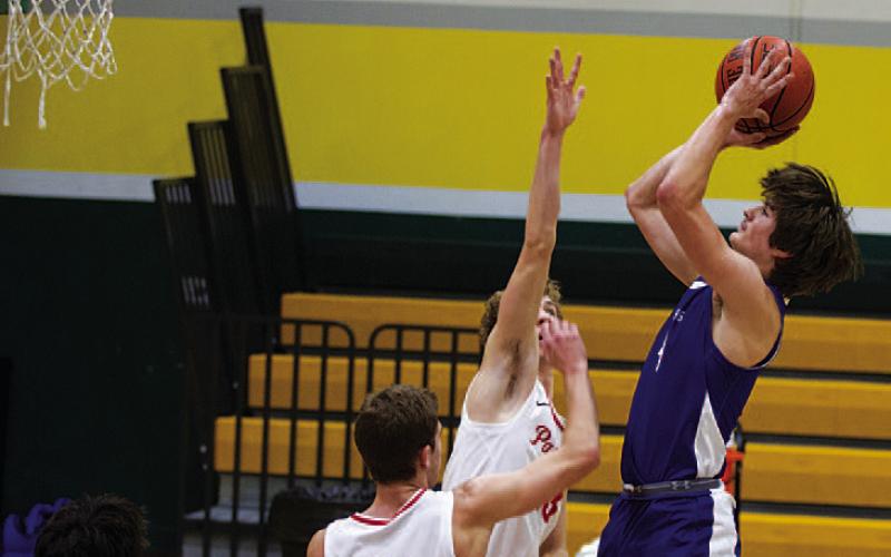 Calum Mitchell shoots over an outstretched hand against Hyde Park. HUNTER KING | DISPATCH RECORD
