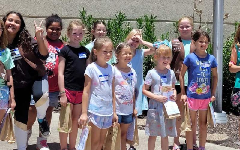 Pictured at the Lampasas Police Department building are, from left to right, Girl Scouts Jenna Paige Linney, Katelynn Rodriguez, Vera-Rose Johnson, Emerson Evans, Karma Driskell, Emma-Lee Bull, Fiona Wharton, Evelyn Peterson, Addison Hammons, Anna Figurski, Belle Wharton and Breanna Kirby. Not pictured: Jesseca Mahoney, Kayleigh Mahoney, Autumn Beavers and Gwen Carey. COURTESY PHOTO