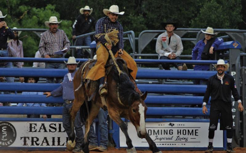 Andrew Garcia holds on tight in his Saturday night Saddle Bronc competition. ERICK MITCHELL | DISPATCH RECORD