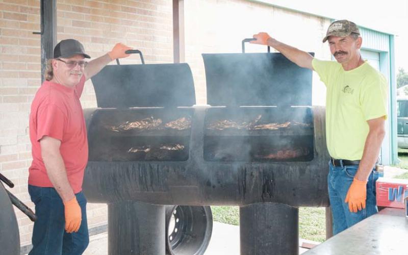 Kempner Volunteer Fire Department volunteers Todd Burkett and James Evans man the barbecue pit during the 2024 KVFD BBQ and Auction fundraiser. File Photo