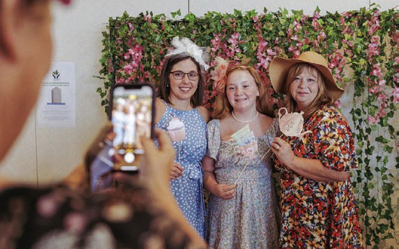 From left to right, Tori Lesley, Anna Figurski and Julie Figurski pose for a photo during Saturday’s “Tea Fit for a Queen” festivities. GABRIELA SANGACHE | DISPATCH RECORD