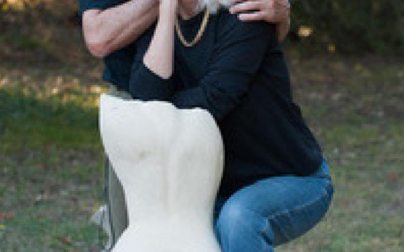 Pablo and Beverly Solomon pose with “Summer,” one of Pablo’s life-size sculptures in limestone. TK DESIGN AUSTIN