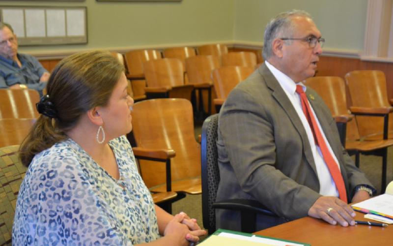 Jail Administrator Cristopher Brister, left, looks on as Sheriff Jess Ramos speaks to county officials during his budget presentation Thursday. MONIQUE BRAND | DISPATCH RECORD