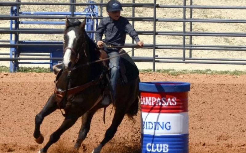 Lucky Bumpas, 8, rides his horse around a barrel during a junior rodeo event in March. COURTESY PHOTO