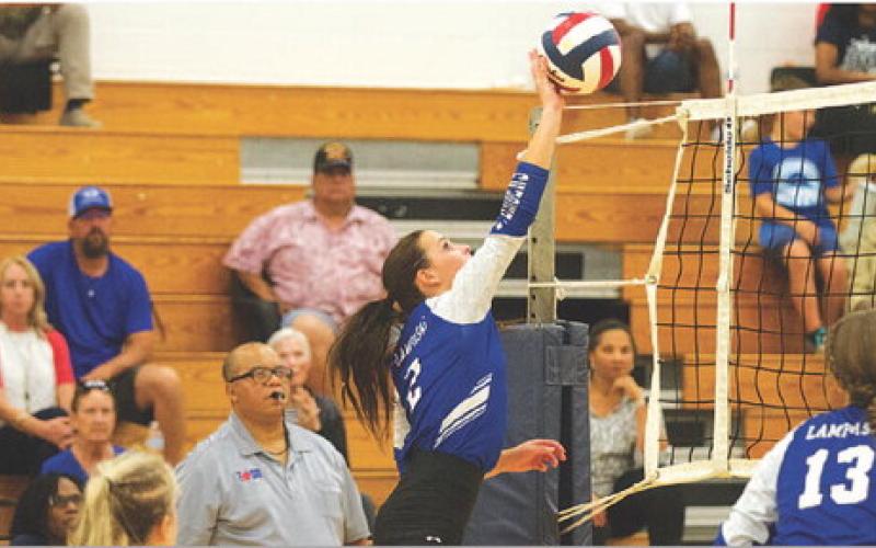 Landry White rises for an attempted kill during an early-season match on the road. HUNTER KING | DISPATCH RECORD