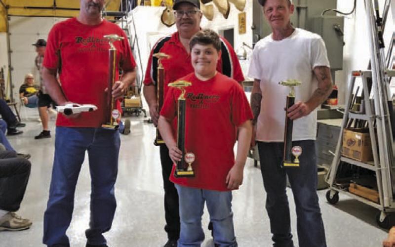 The Redliners Automotive Club held its Winter Nationals Blast Car Races March 11, hosted by Walt and Joann Birchfield in Lometa. Lunch was served, then the races began. Jace Wenger, pictured in front, won first place stock car. In back, from left, are Scott Carrigan, first place super stock car winner; Dave Arens, second place stock car; and Luke Mortensen, the extra driver for Jace, since the 11-year-old brought three cars to race at the event. COURTESY PHOTO