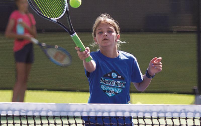 HUNTER KING | DISPATCH RECORD Madelynn White practices net work at tennis camp.