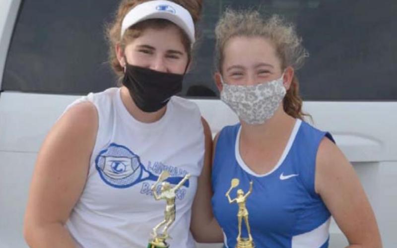 Kailr Clements and Abby Valdez show their third-place doubles trophies from the Cedar Park tournament. KENNETH PEISER | COURTESY PHOTO