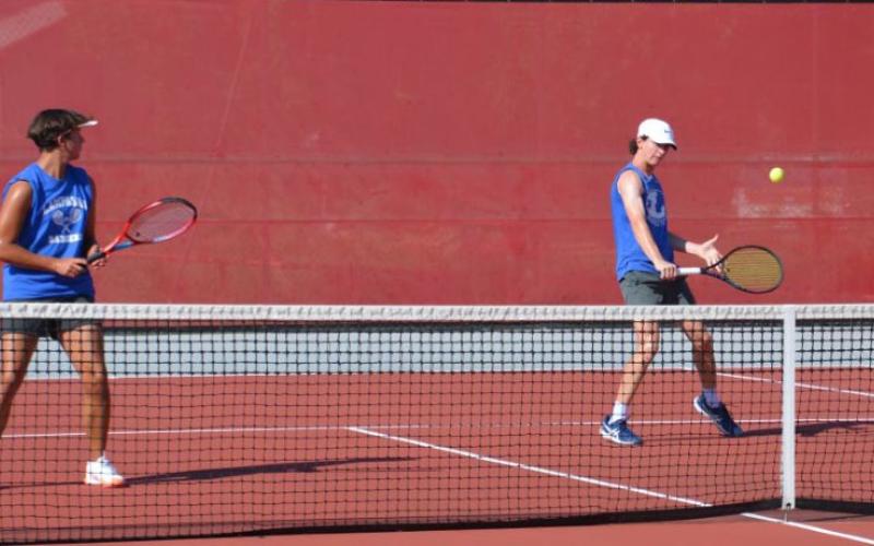 HUNTER KING | DISPATCH RECORD Elijah Copeland, right, plays a shot as Clyde Ashfield looks on during their doubles match against Glen Rose.