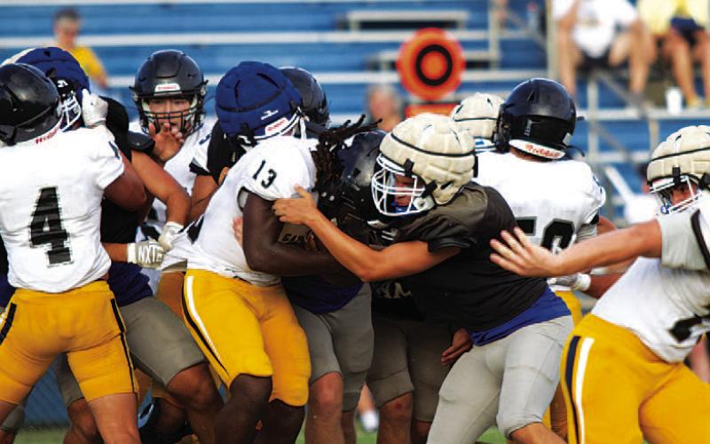 HUNTER KING | DISPATCH RECORD Ayden Vanliew meets the running back in the hole and makes a tackle against Gatesville.