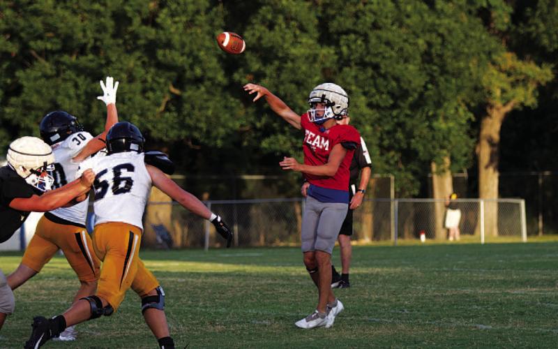Bryson Roberts drops off a short pass during the scrimmage last Friday. HUNTER KING | DISPATCH RECORD