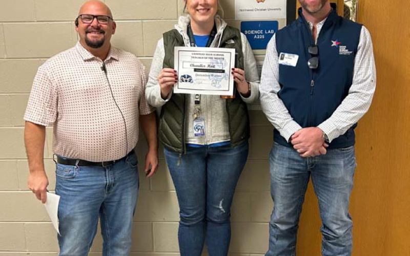 Science teacher and coach Chandler Hail, center, was named the December Teacher of the Month at Lampasas High School. “The students raved about her on and off the court,” said Assistant Principal Ryan Race, at left. Also pictured with Hail is Clay Phillips of Texas Farm Bureau Insurance. COURTESY PHOTO