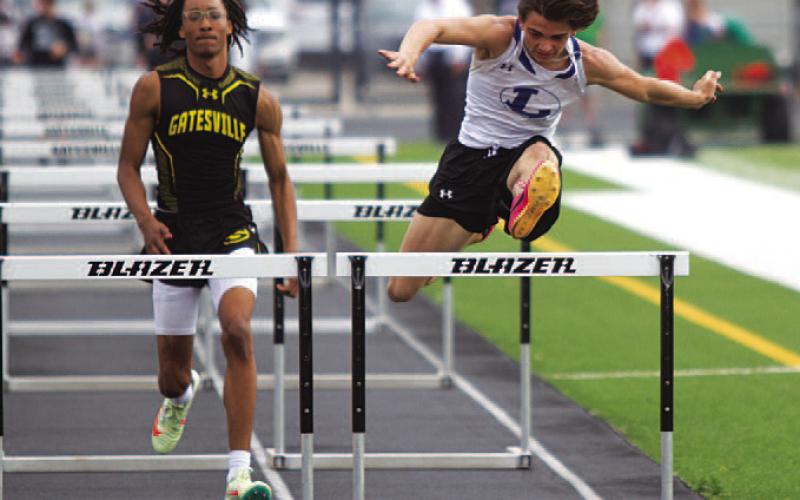 Asa White leaps over the final hurdle during the 110-meter race where he placed fourth last week. HUNTER KING | DISPATCH RECORD