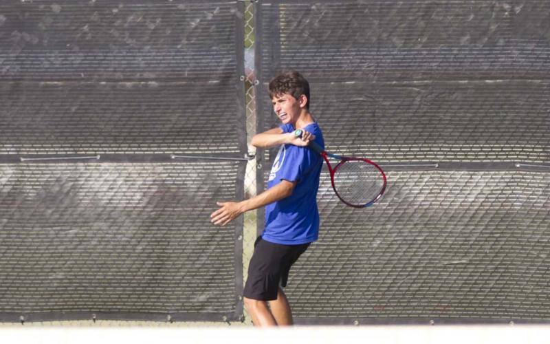 Clayton Shaw finishes on a forehand shot during a recent tennis match in Lampasas. Tennis started district play on Thursday against Stephenville. HUNTER KING | DISPATCH RECORD