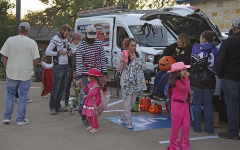 Area children and parents make their way through the different stops of Tuesday night’s Trunk or Treat event at Kempner City Hall, where costumes and sweet treats were in abundance. ERICK MITCHELL | DISPATCH RECORD