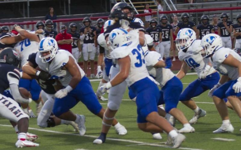 Sosa Sokimi breaks through the Wimberley offensive line to make a tackle during the game on Friday. HUNTER KING | DISPATCH RECORD
