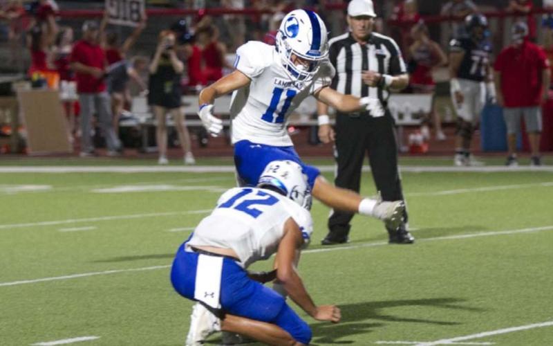 Landon Richardson kicks through the ball during a field goal attempt on Friday on the road against Wimberley. HUNTER KING | DISPATCH RECORD