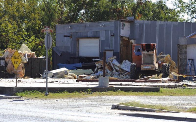ERICK MITCHELL | DISPATCH RECORD Mike Irvin has begun demolition on property at the intersection of East Fourth Street and Hackberry Street near the Lampasas downtown square. Irvin plans to develop the site for an upscale restaurant that overlooks Sulphur Creek.