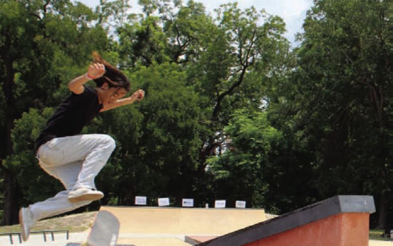Zhen Brewer flips his board over the stairs, impressing the Born to Soar Skate Competition crowd. CHLOE COWDREY | DISPATCH RECORD