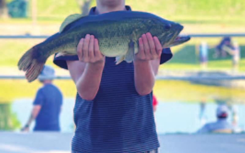 Bobby Chaney is all smiles with his catch from the fishing derby. MONIQUE BRAND | DISPATCH RECORD