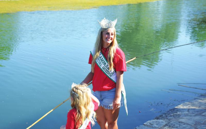 Miss Spring Ho Meredith McBeth tries her hand at fishing with the cane pole at the creek. MONIQUE BRAND | DISPATCH RECORD
