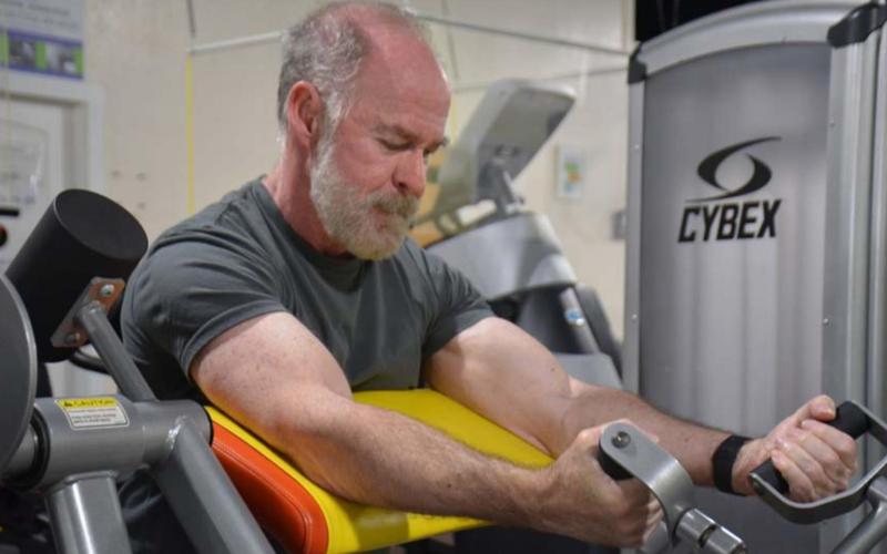 Part of Day One Fitness member Patrick Thompson’s workout routine includes arm curls. The 65-year-old is one of many Lampasans who strive to stay fit year round. MONIQUE BRAND | DISPATCH RECORD