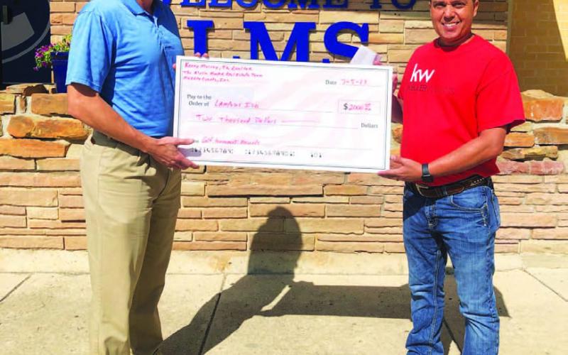 Kenny Murray, at left, presented checks to both Lometa Superintendent Rob Moore and to Lampasas Superintendent Chane Rascoe, from the proceeds of his golf tournament this summer. COURTESY PHOTO | KENNY MURRAY