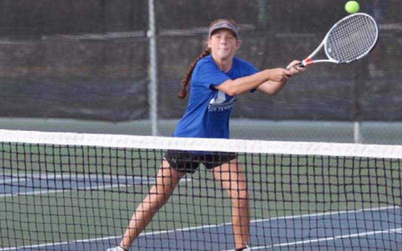 Allison Valdez reaches out on her backhand during a doubles match with her sister, Abby, on Friday. HUNTER KING | DISPATCH RECORD
