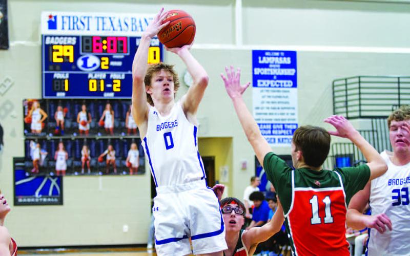Peyton Sisson shoots over a defender during last basketball season. FILE PHOTO