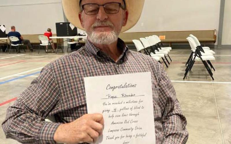 Royce Rhoades shows the certificate he received for donations of 4 gallons of blood through the American Red Cross. COURTESY PHOTO