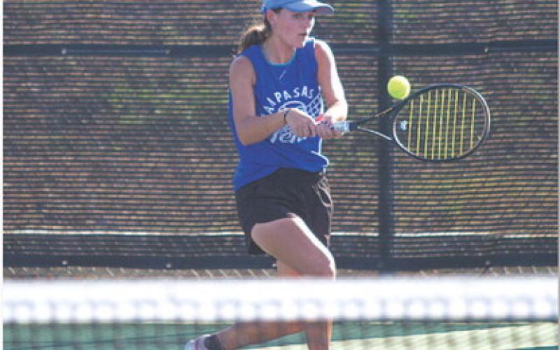 Caroline White hits a backhand during her doubles match with Allison Valdez. HUNTER KING | DISPATCH RECORD