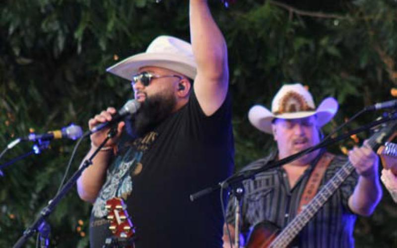 Kin Faux lead singer Rico Gonzales interacts with a welcoming crowd at Friday night’s Spring Ho Concert on the Square. Lampasans enjoyed the summer breeze and a night of great music and dancing. joycesarah mccabe | dispatch record