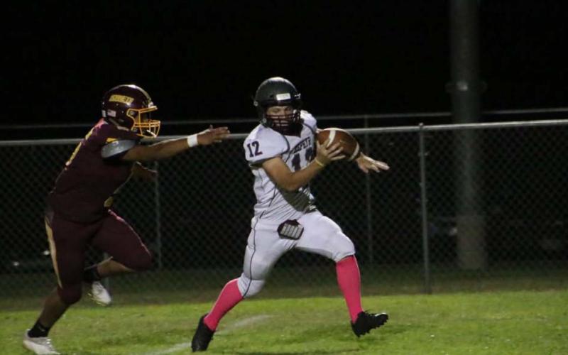 Elijah Golzales chases down the Zephyr quarterback during the Hornets’ dominant win last Friday. MEGAN LUSTY | DISPATCH RECORD