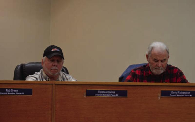 Place 2 Councilman Thomas Combs, at left, and Place 1 Councilman Dave Richardson glance at their notes during last week’s Kempner City Council meeting. ERICK MITCHELL | DISPATCH RECORD