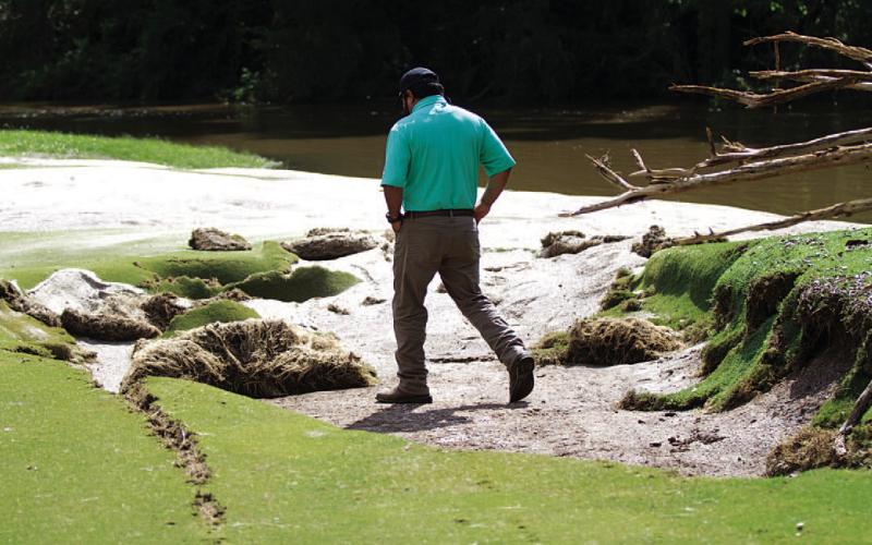 Golf Course Manager Kris Morin surveys damage to the green on Hole No. 2 at the Hancock Park municipal course. The green will have to be completely reconstructed, he said. For more photos of damage sustained at the golf course, see page 8. HUNTER KING | DISPATCH RECORD