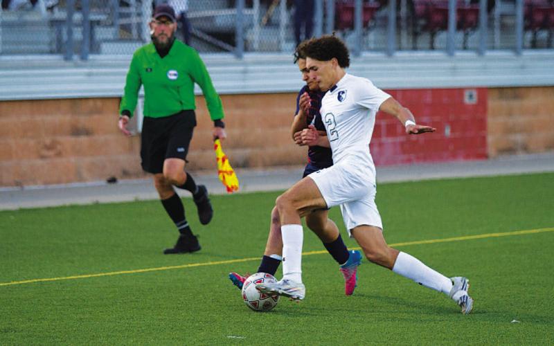 HUNTER KING | DISPATCH RECORD Ayden Shaw challenges for a ball during his final match with the Badger soccer program.