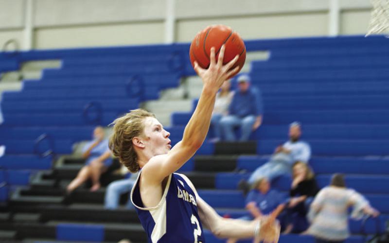 HUNTER KING | DISPATCH RECORD Peyton Sisson rises up for a fast-break layup, accounting for two of his 13 points against the Hornets.