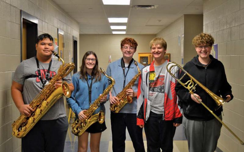 erick mitchell | dispatch record Band members, from left, Sasa Soki, Maddi Griffin, Jacob Whaley, Alexander Thorne and Charlie Pekins pose with their instruments. All five placed in the top 12 for the state jazz band competition with their respective instruments.