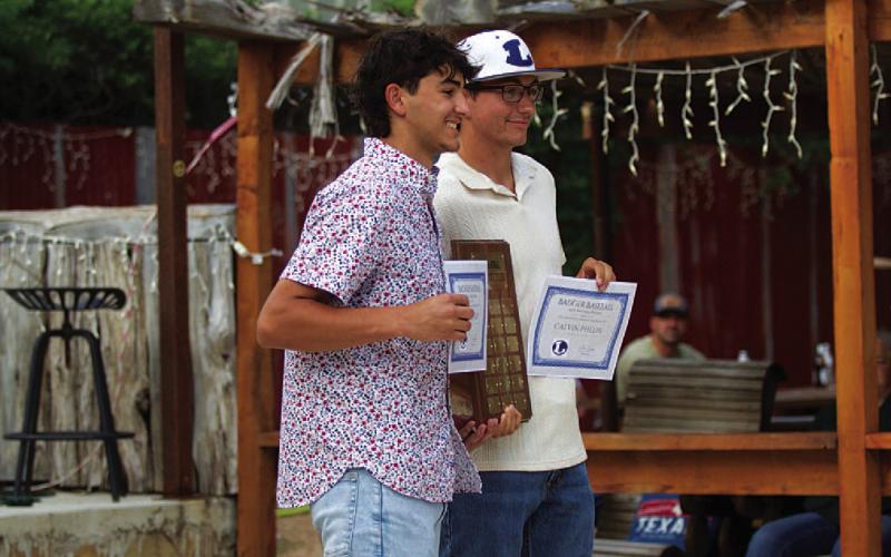Kade Landry, left, and Calvin Phelps show off the Most Valuable Pitcher award at the banquet. HUNTER KING | DISPATCH RECORD