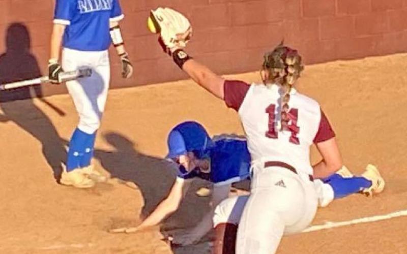 Kali Hunter scores on a passed ball in the Lady Badgers’ 15-4 victory on the road Friday. JAMIE SYX | COURTESY PHOTO