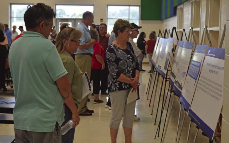 Lampasas County residents take a look at poster boards depicting plans for the Texas Department of Transportation’s U.S. Highway 190 project at Big Divide Road. ERICK MITCHELL | DISPATCH RECORD