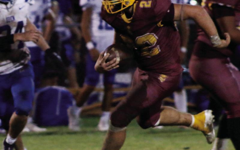 MASON HINES | DISPATCH RECORD Lukas Smailus-Cruz (22) looks for space during a hard run. Smailus-Cruz led the Hornets in rushing with 178 yards and three scores.