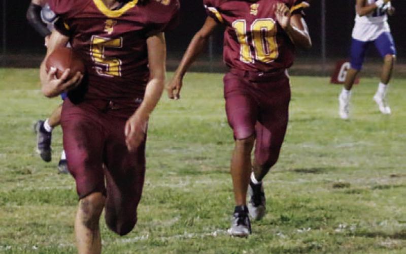 MASON HINES | DISPATCH RECORD Johnny Miller (5) returns a fumble with Jeremiah Torres blocking.