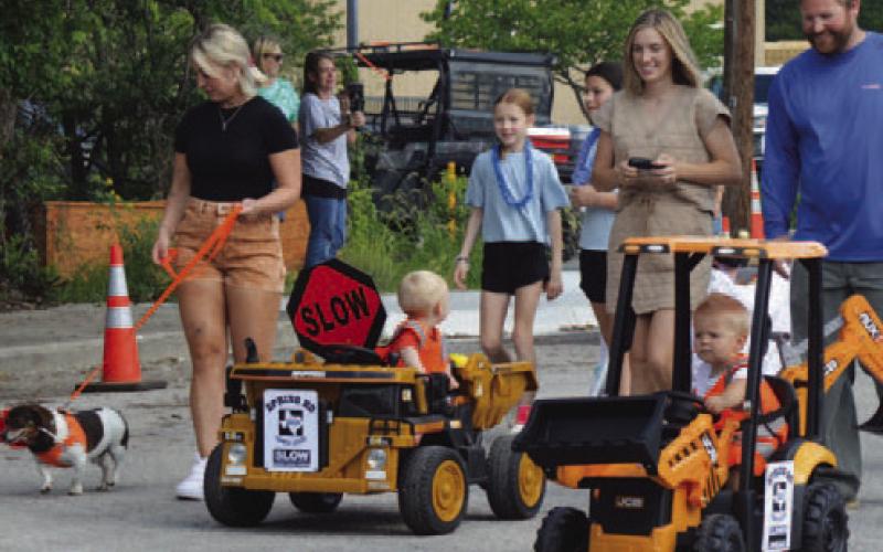 These Pet Parade entrants are riding in style in their “construction” vehicles. Participants are encouraged to dress in costume and embrace the Spring Ho theme -- which this year is “Stars, Stripes and Spring Ho Nights.” FILE PHOTO