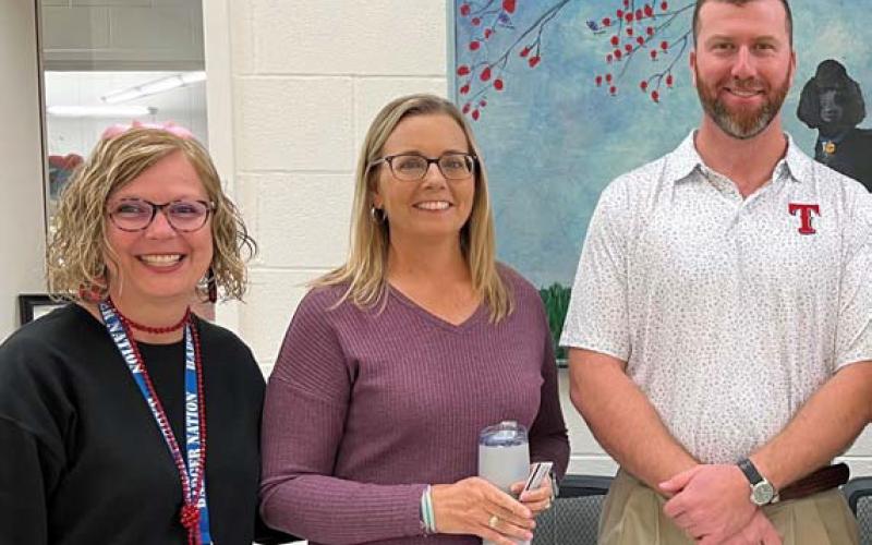 Clay Phillips of Farm Bureau Insurance was on hand to honor October educators of the month at Taylor Creek Elementary School. Each received a Texas Farm Bureau insulated mug and a Mojo’s gift card. Pictured with Phillips are Principal Shona Moore and Jennifer Hughes, Teacher of the Month. courtesy photo