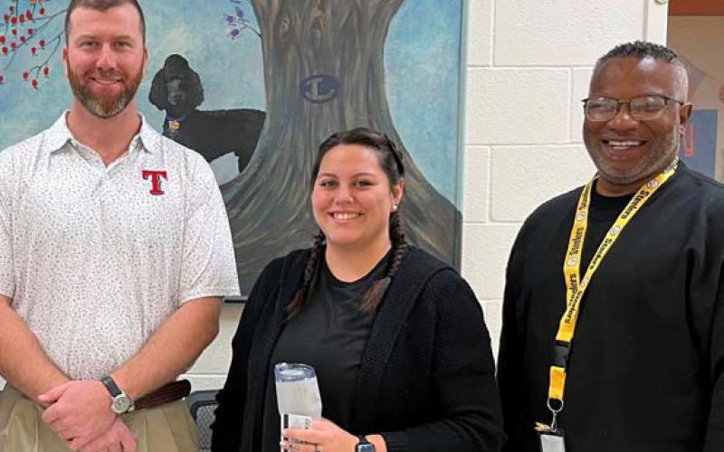 Clay Phillips of Texas Farm Bureau Insurance, at left, presented Emily Baum with tokens of appreciation to recognize her designation as Paraprofessional of the Month at Taylor Creek Elementary. They are joined by Assistant Princpal Mark Sheppard. courtesy photo